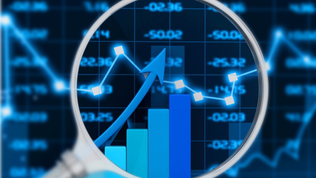 Magnifying glass highlights blue bars and an upward arrow on a stock chart, representing market analysis and growth.