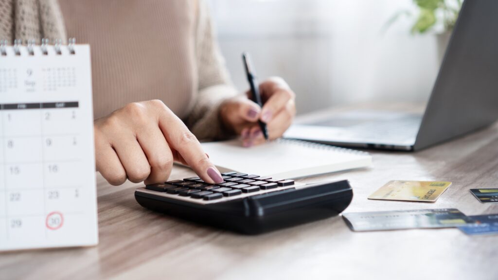 Person calculating his net worth and finances