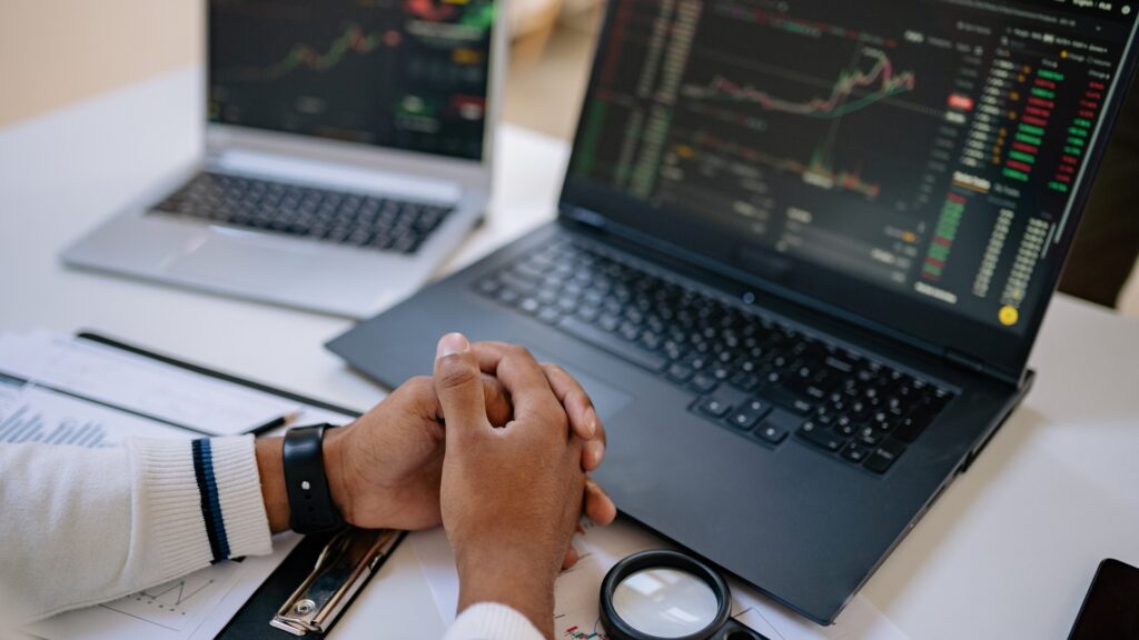 Person in front of computer doing trading and waiting